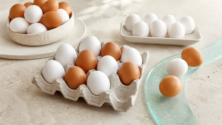 White and brown eggs arranged in soft natural daylight