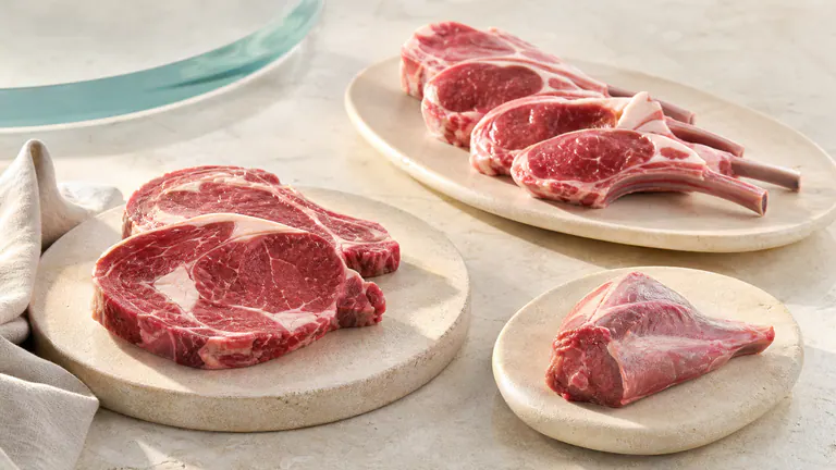 Selected red meat cuts on a dark natural surface